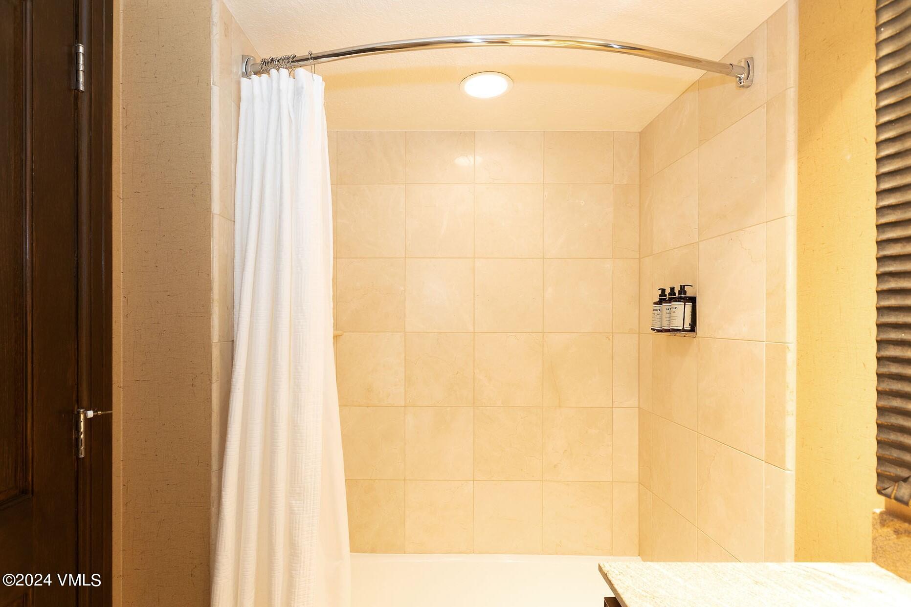 210 Offerson Road, Unit R215 WEEKS 13 & 14 Beaver Creek, CO 81620 - Photo 19 of 32 a bathroom with a shower