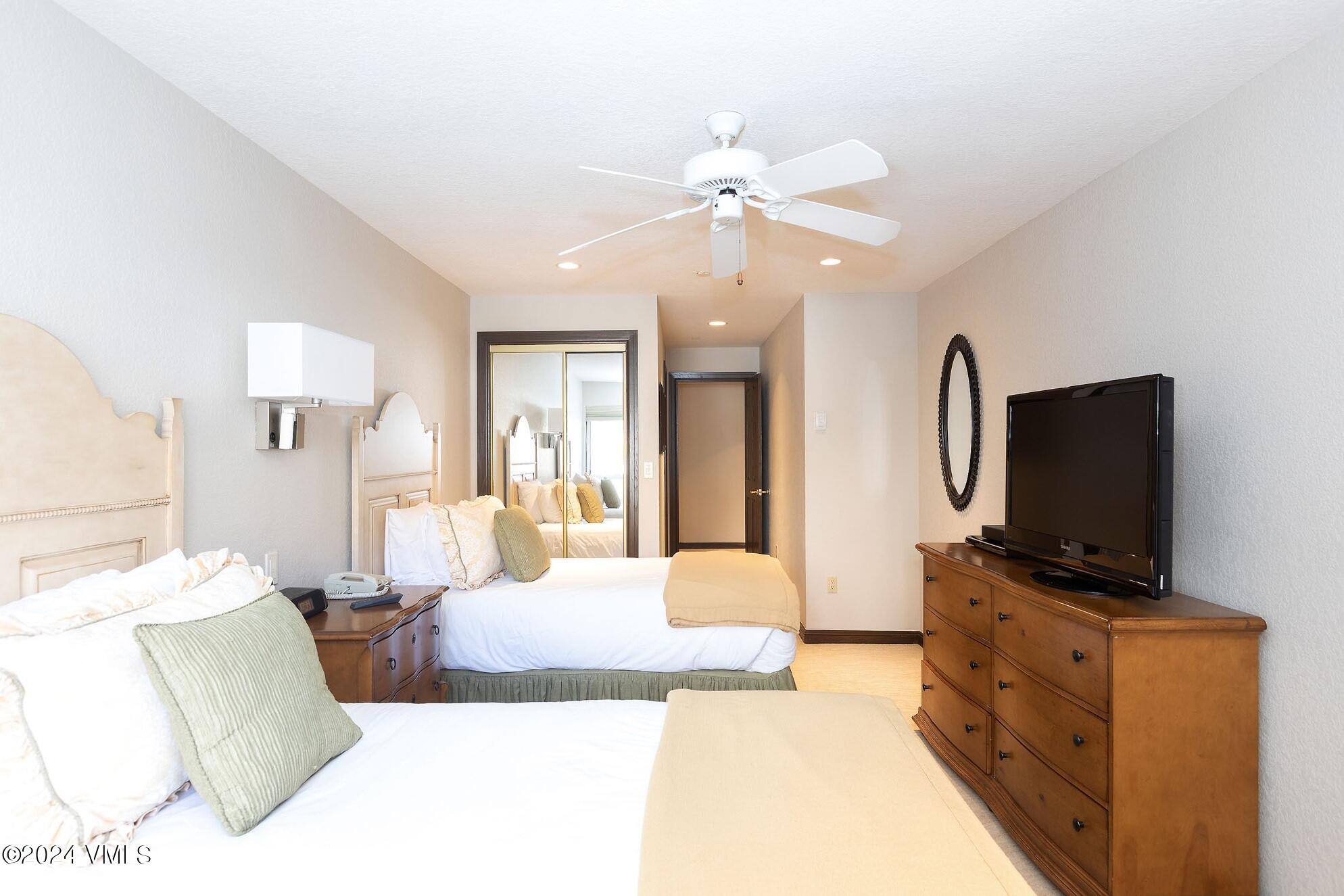 210 Offerson Road, Unit R215 WEEKS 13 & 14 Beaver Creek, CO 81620 - Photo 21 of 32 a bedroom with a bed and a flat screen tv