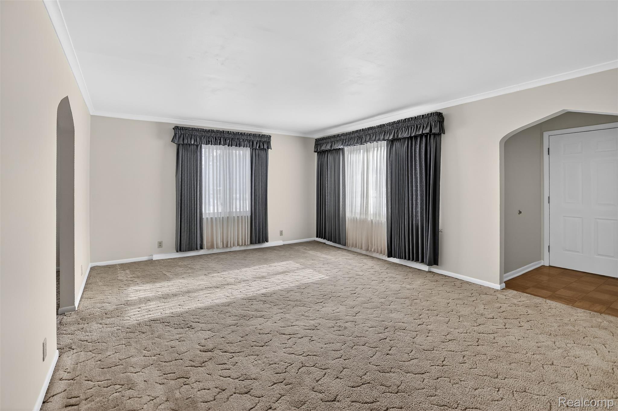 3241 Curtis Road Birch Run, MI 48415 - Photo 12 of 47 Carpeted spare room with arched walkways and crown molding