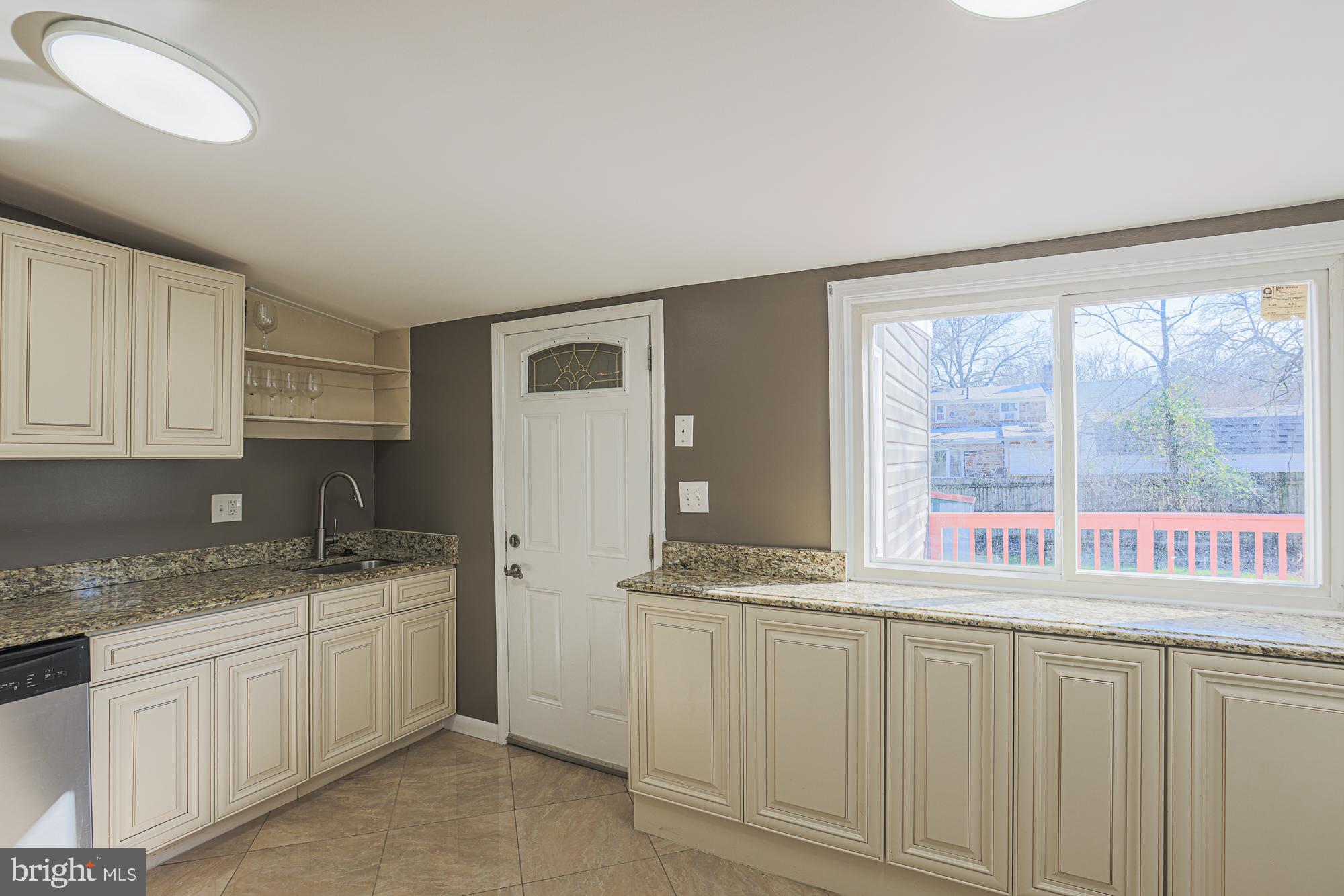 2507 Taney Road Baltimore, MD 21209 - Photo 20 of 58 a kitchen with granite countertop a sink and a white cabinets