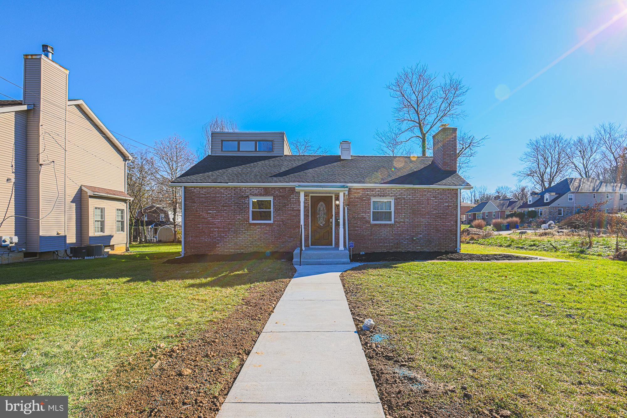 2507 Taney Road Baltimore, MD 21209 - Photo 2 of 58 a front view of a house with yard and garage