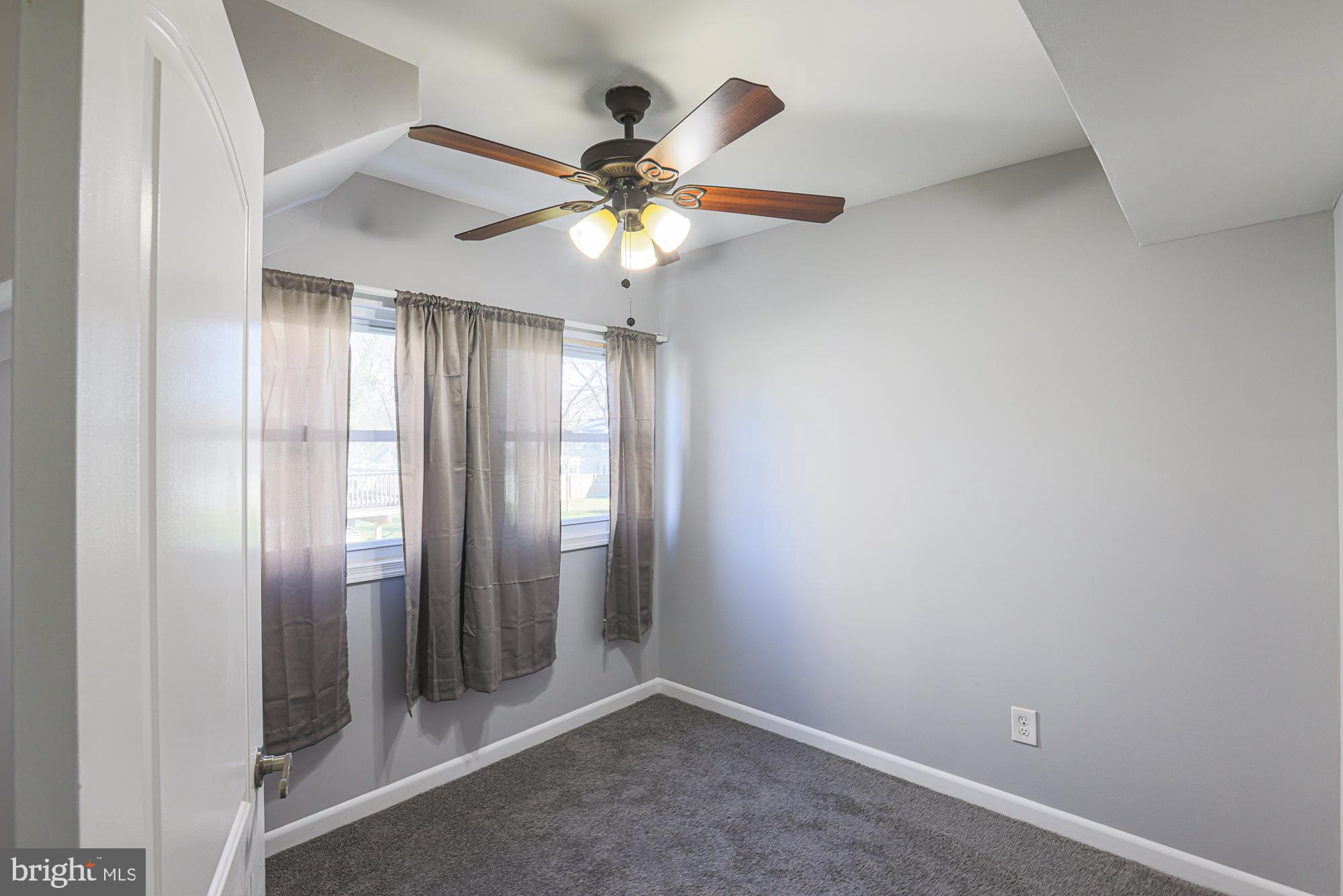 2507 Taney Road Baltimore, MD 21209 - Photo 26 of 58 an empty room with windows and fan
