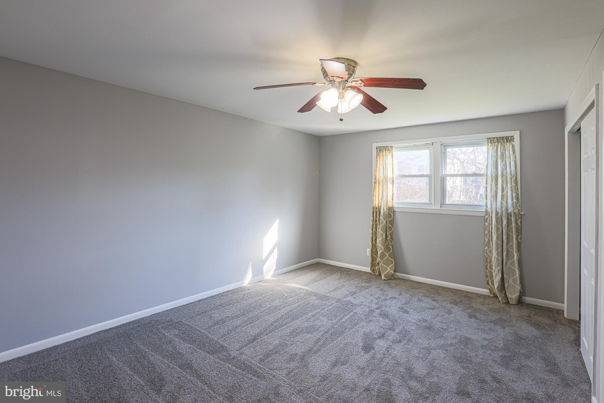 2507 Taney Road Baltimore, MD 21209 - Photo 29 of 58 an empty room with windows and fan
