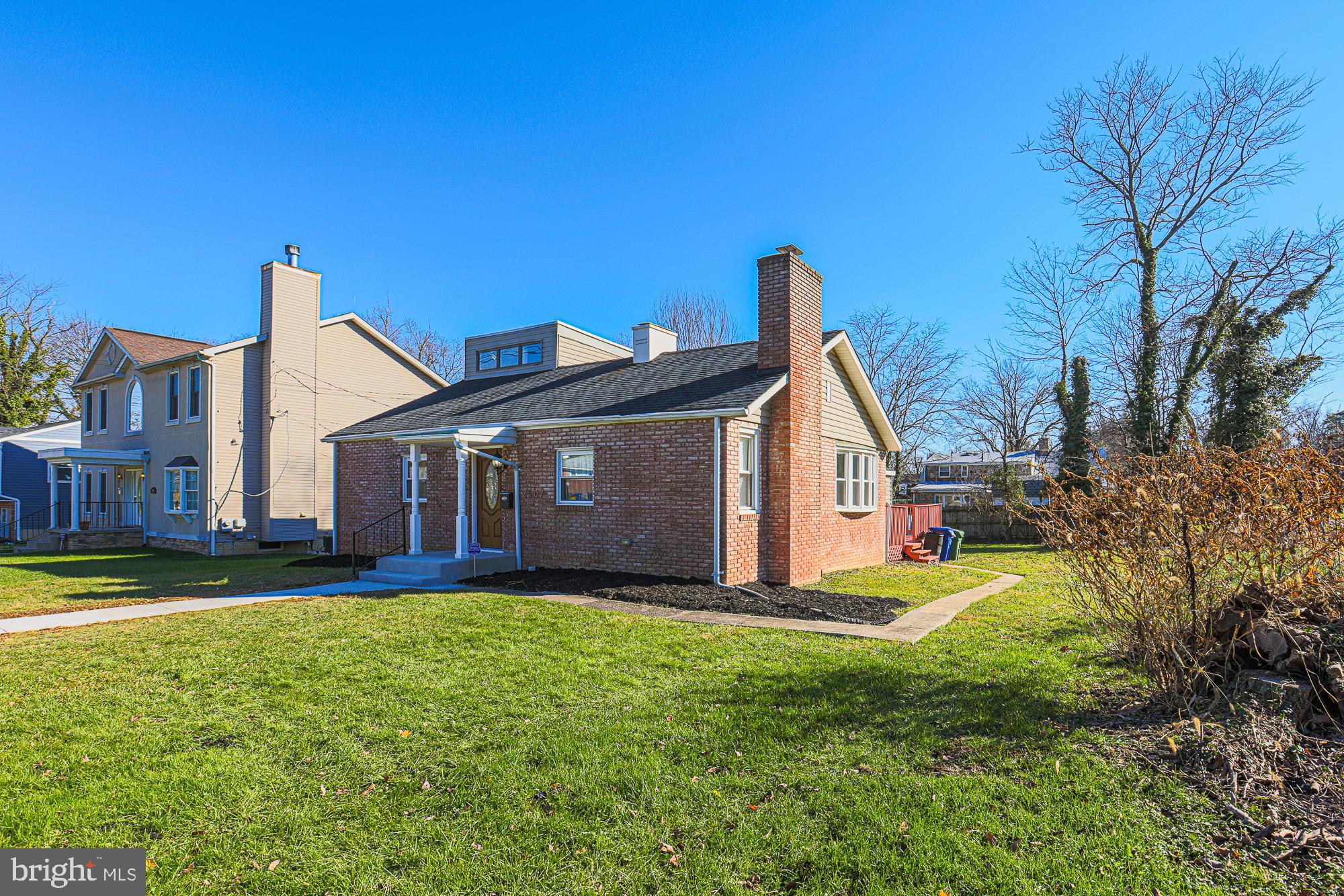 2507 Taney Road Baltimore, MD 21209 - Photo 3 of 58 a view of a house with a big yard and large trees