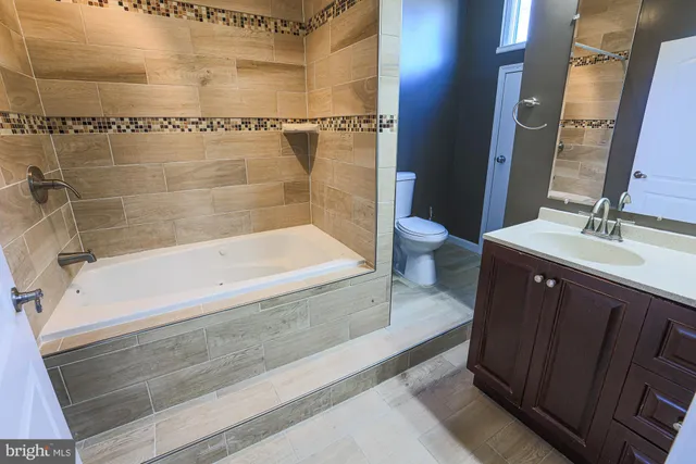 a bathroom with a bathtub and a sink