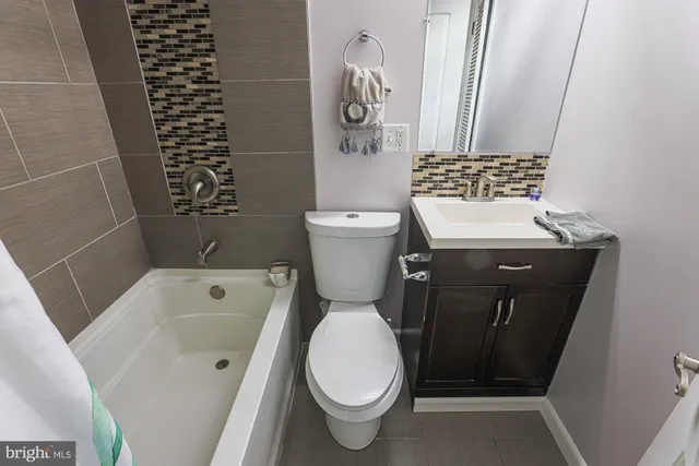 a bathroom with a sink a toilet and a shower