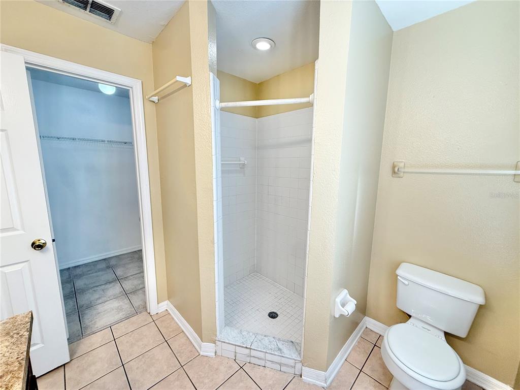 4695 Prairie Point Boulevard Kissimmee, FL 34746 - Photo 14 of 27 a bathroom with a shower and a toilet