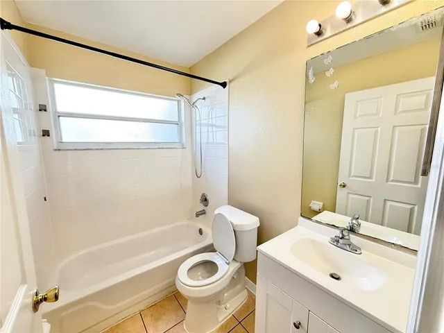 a bathroom with a sink mirror toilet and bathtub