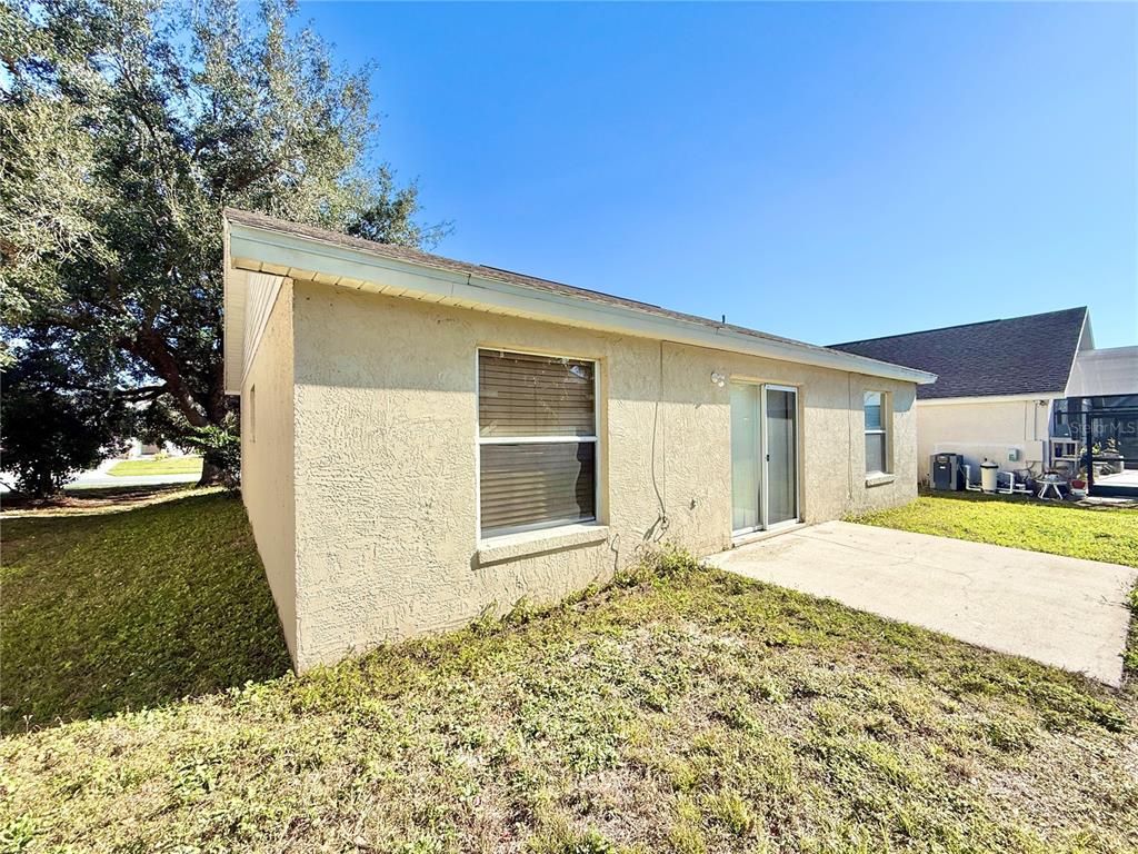 4695 Prairie Point Boulevard Kissimmee, FL 34746 - Photo 24 of 27 a front view of a house with a yard
