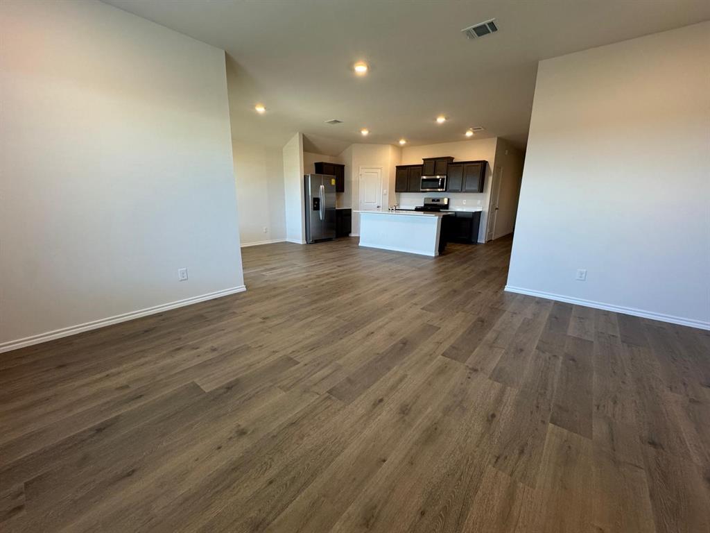 3905 Turquoise Avenue Celina, TX 75009 - Photo 2 of 19 a view of kitchen with kitchen island wooden floor center island and stainless steel appliances