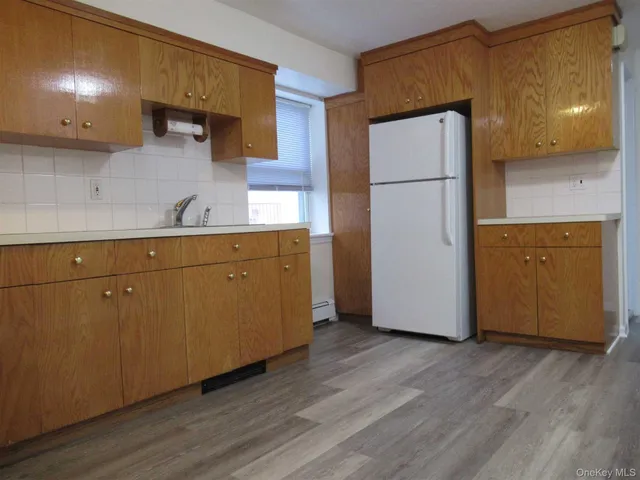 a kitchen with a refrigerator and a sink