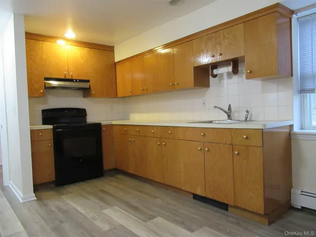 a kitchen with a sink cabinets and appliances