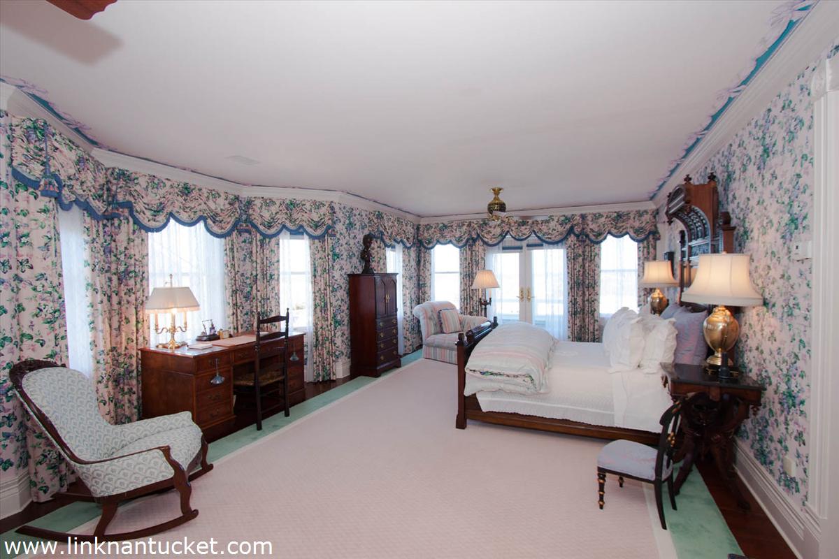 27 Cliff Road Nantucket, MA 02554 - Photo 18 of 32 a bedroom with furniture and a large window