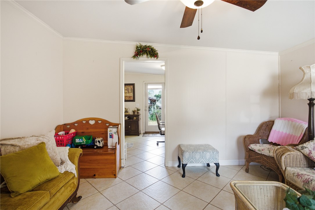 108 Hodge Street Abbeville, SC 29620 - Photo 14 of 39 A well-lit sitting area with tiled flooring, leading to a bright entryway with outdoor access.