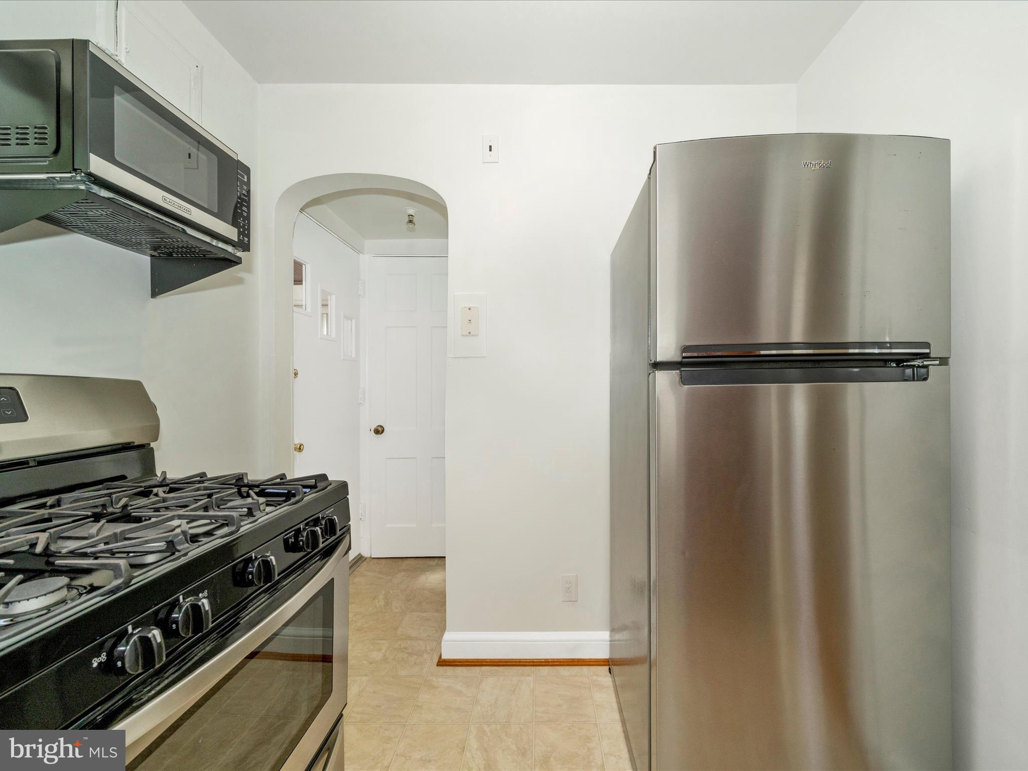9405 Flower Avenue Silver Spring, MD 20901 - Photo 17 of 51 a kitchen with stainless steel appliances granite countertop a refrigerator and a stove