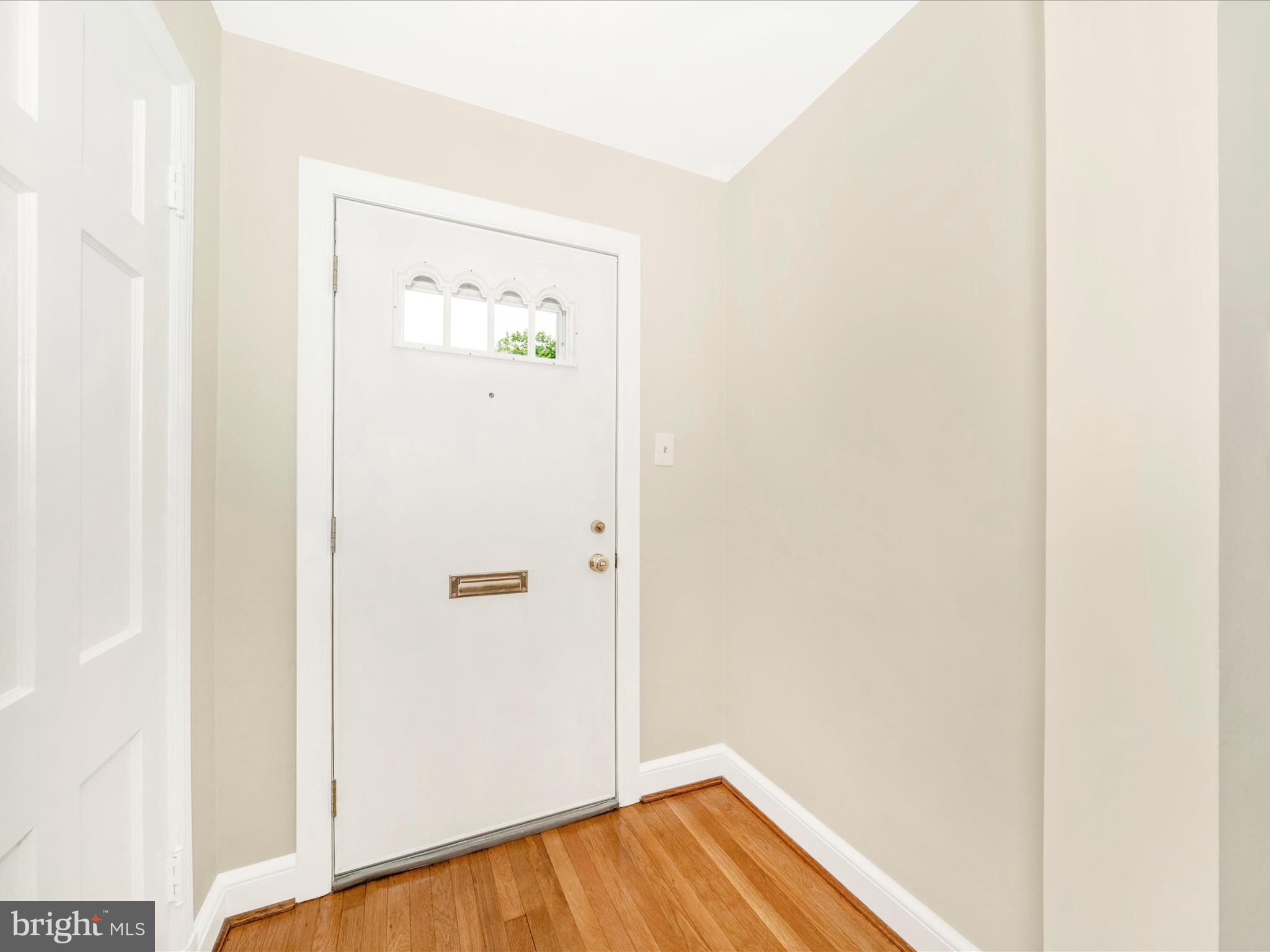 9405 Flower Avenue Silver Spring, MD 20901 - Photo 3 of 51 a view of a hallway with wooden floor