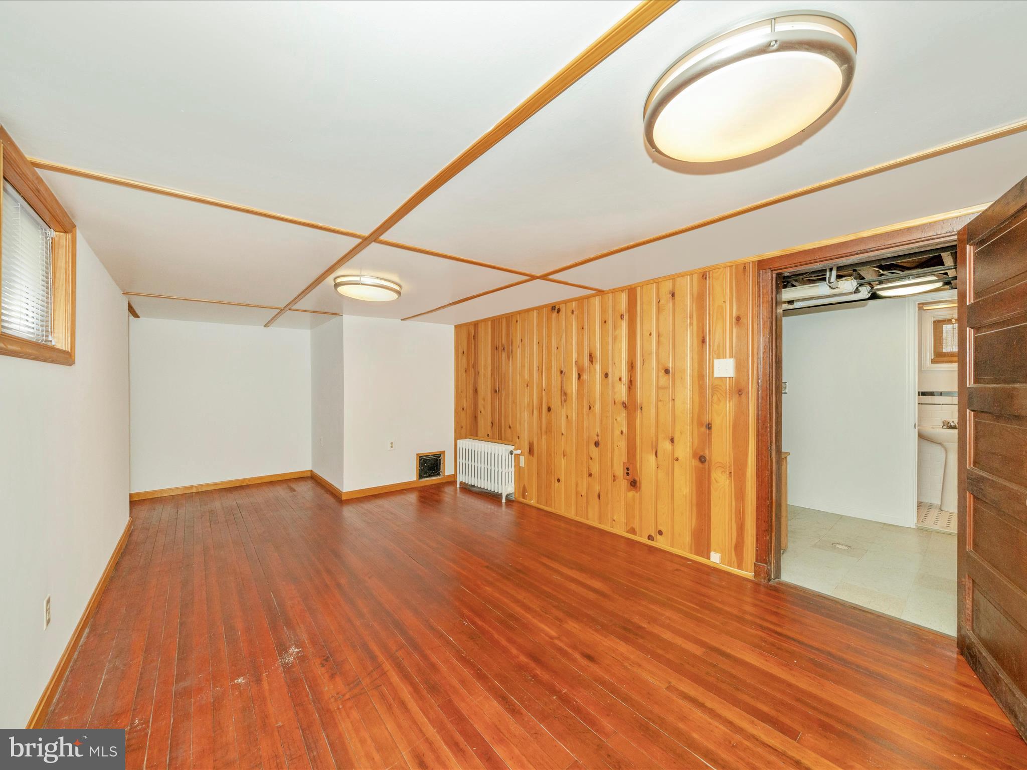 9405 Flower Avenue Silver Spring, MD 20901 - Photo 34 of 51 a view of an empty room with wooden floor and a window