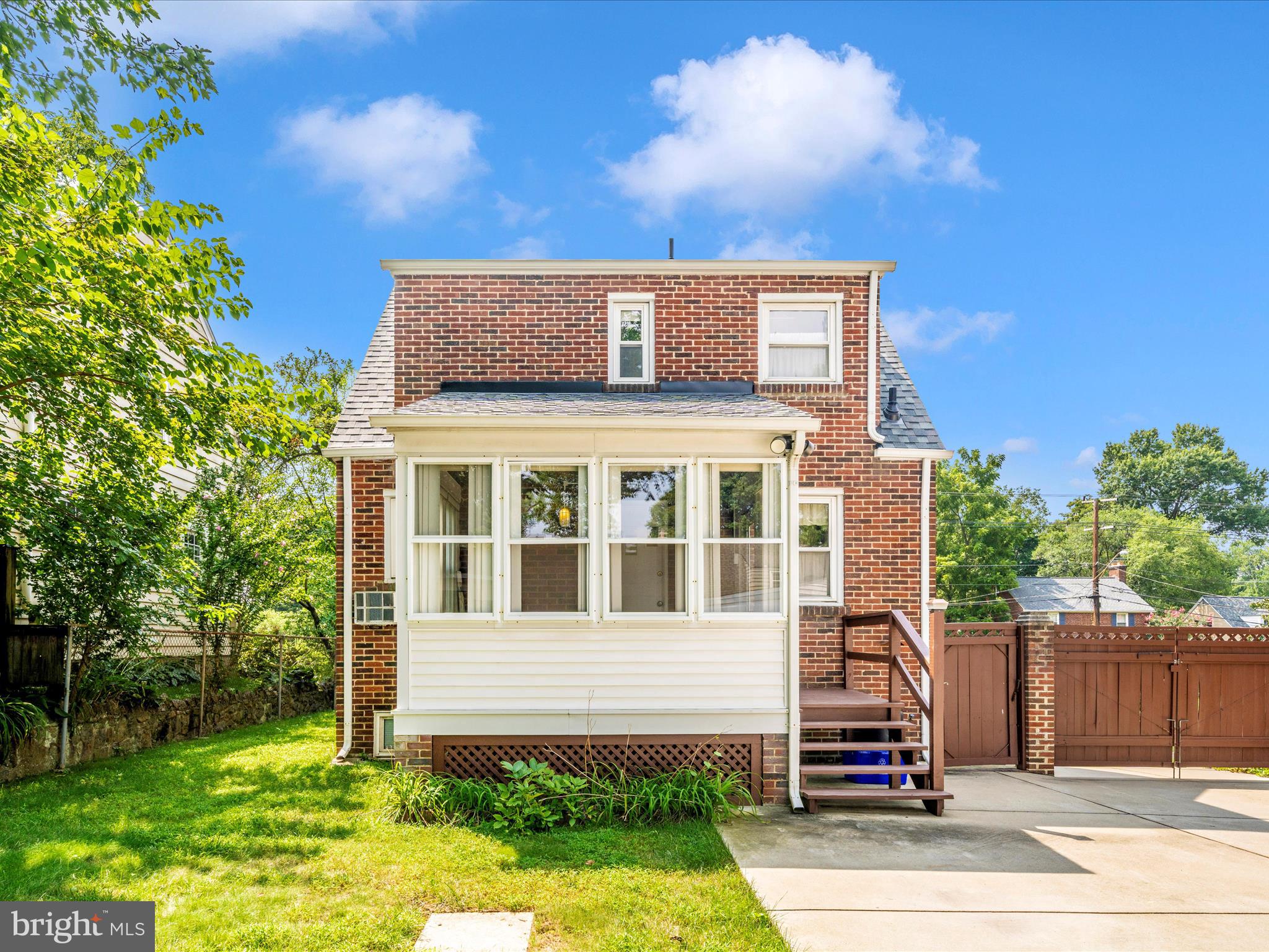 9405 Flower Avenue Silver Spring, MD 20901 - Photo 39 of 51 a front view of a house with a garden
