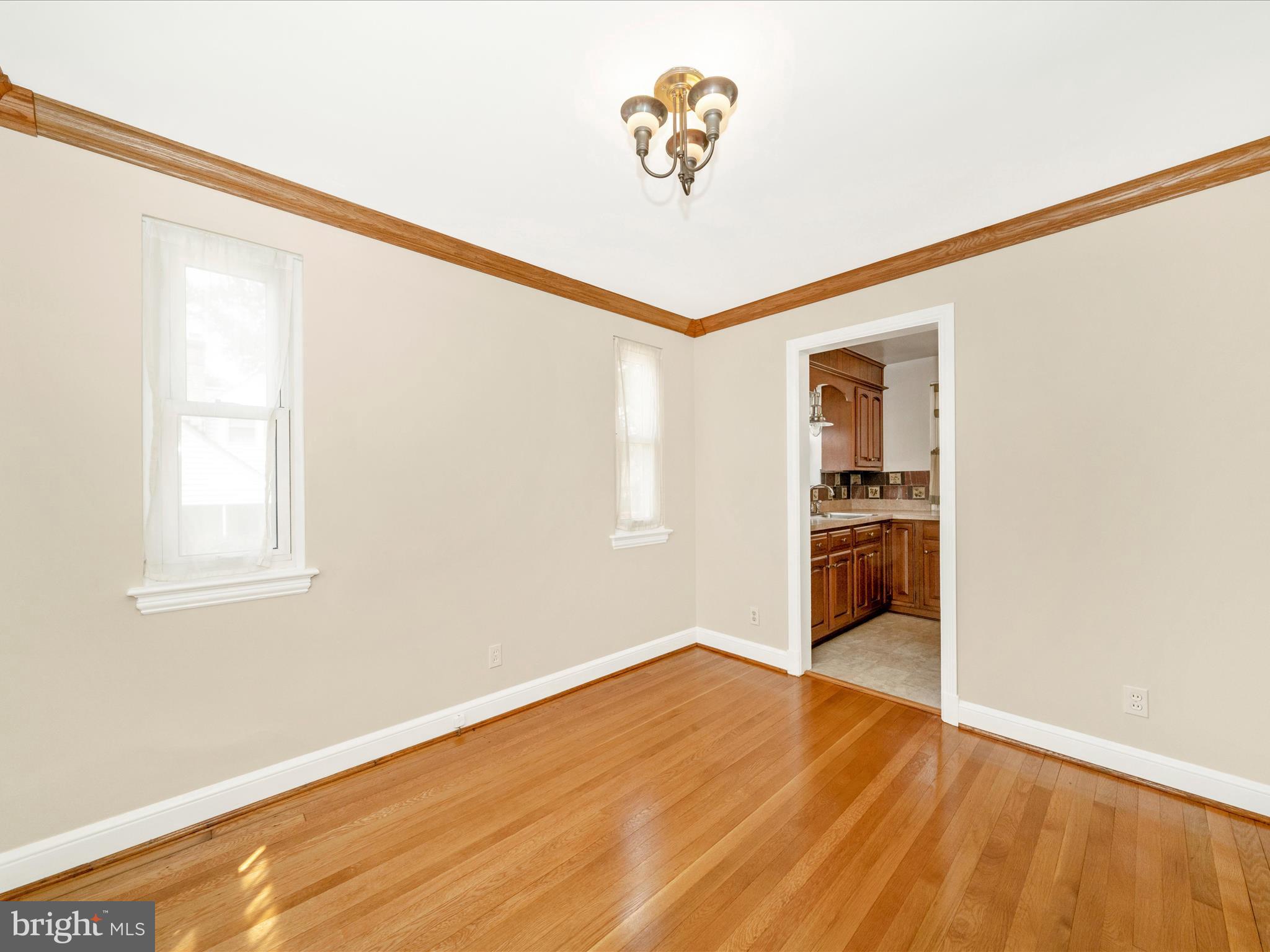 9405 Flower Avenue Silver Spring, MD 20901 - Photo 10 of 51 a view of a room with wooden floor and a window
