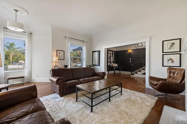 a view of a dining room with furniture a chandelier and wooden floor