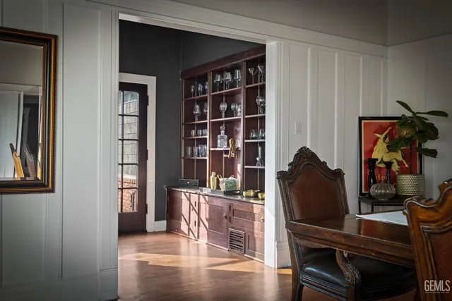 a kitchen with stainless steel appliances kitchen island granite countertop a refrigerator a stove and a sink with wooden floor