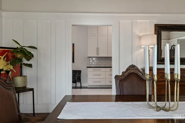 a kitchen with a table chairs and refrigerator
