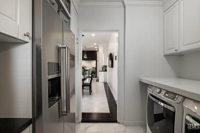 a view of a patio with table and chairs under an umbrella