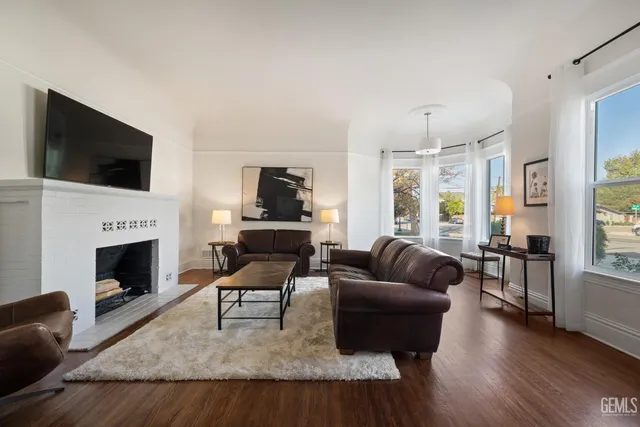 a living room with furniture and a fireplace