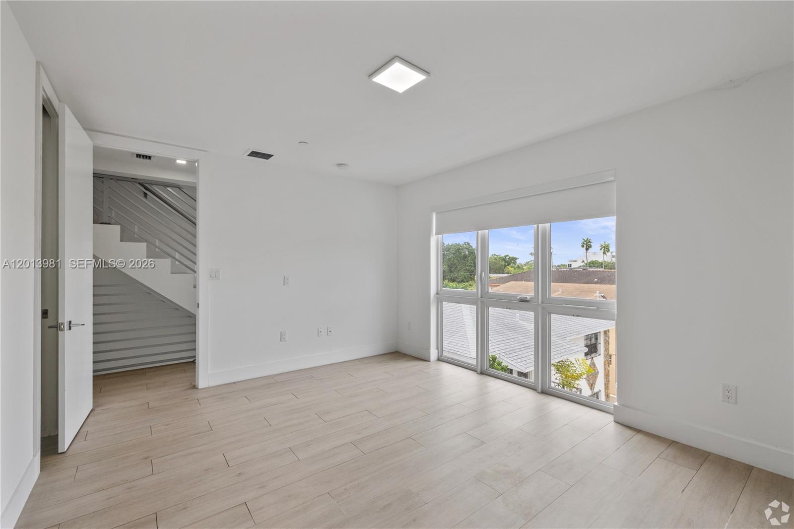 434 Southwest 10th Street, Unit A Miami, FL 33130 - Photo 12 of 23 an empty room with sliding door and mountain view
