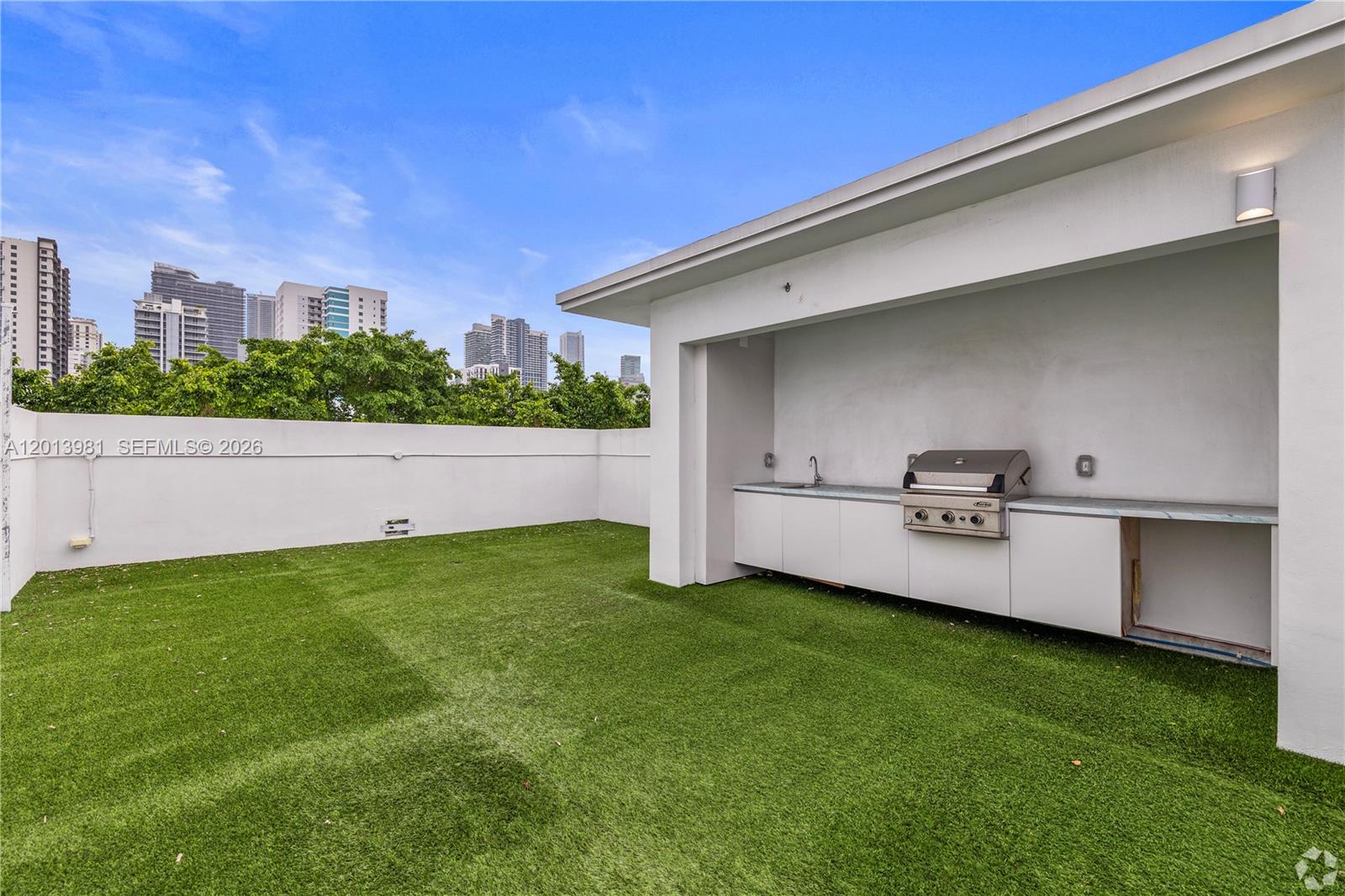 434 Southwest 10th Street, Unit A Miami, FL 33130 - Photo 16 of 23 a view of a backyard with lawn chairs and large tree