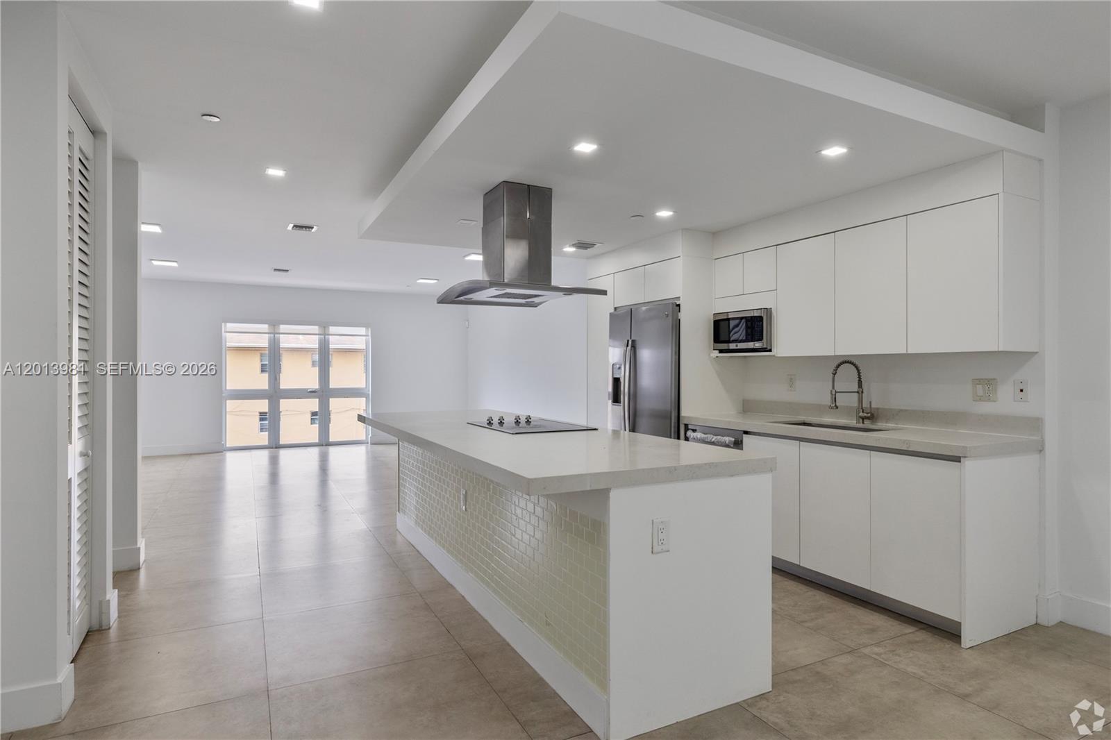 434 Southwest 10th Street, Unit A Miami, FL 33130 - Photo 2 of 23 a large kitchen with stainless steel appliances granite countertop a lot of counter space and wooden floors