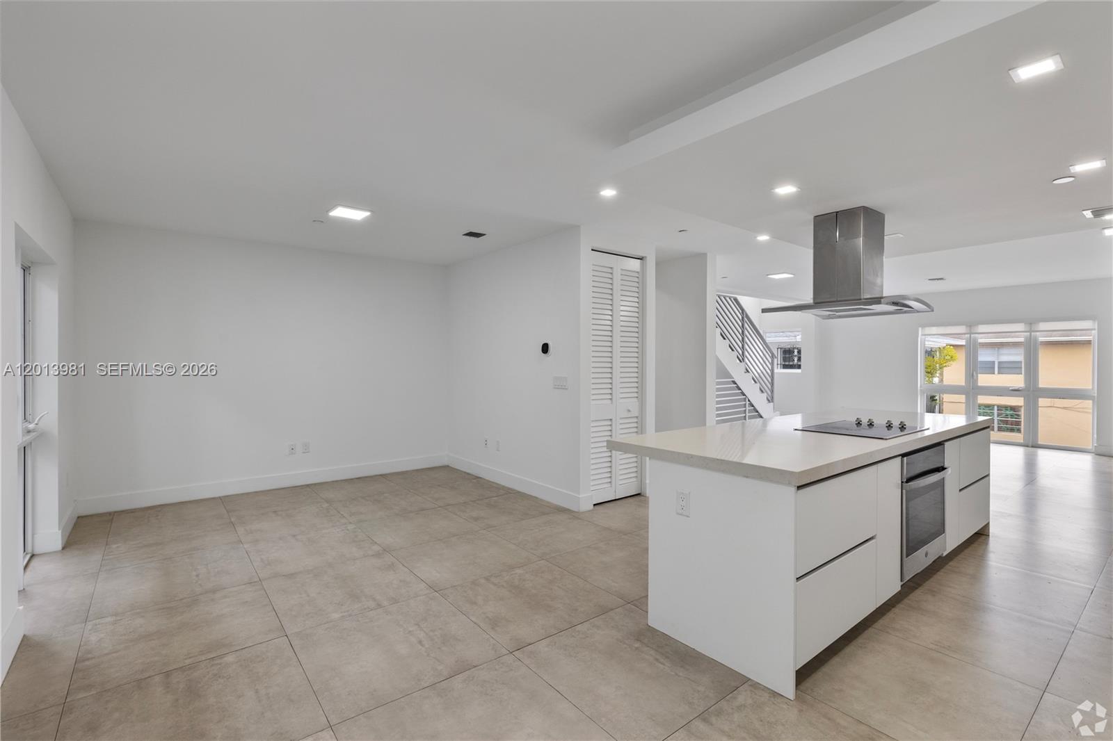 434 Southwest 10th Street, Unit A Miami, FL 33130 - Photo 3 of 23 a kitchen with stainless steel appliances granite countertop a sink and a stove