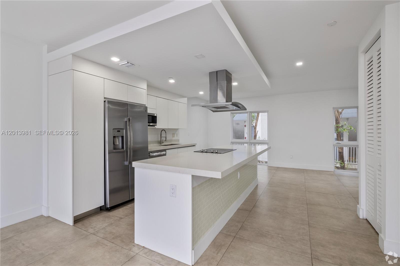 434 Southwest 10th Street, Unit A Miami, FL 33130 - Photo 5 of 23 a large kitchen with stainless steel appliances granite countertop a refrigerator and a sink