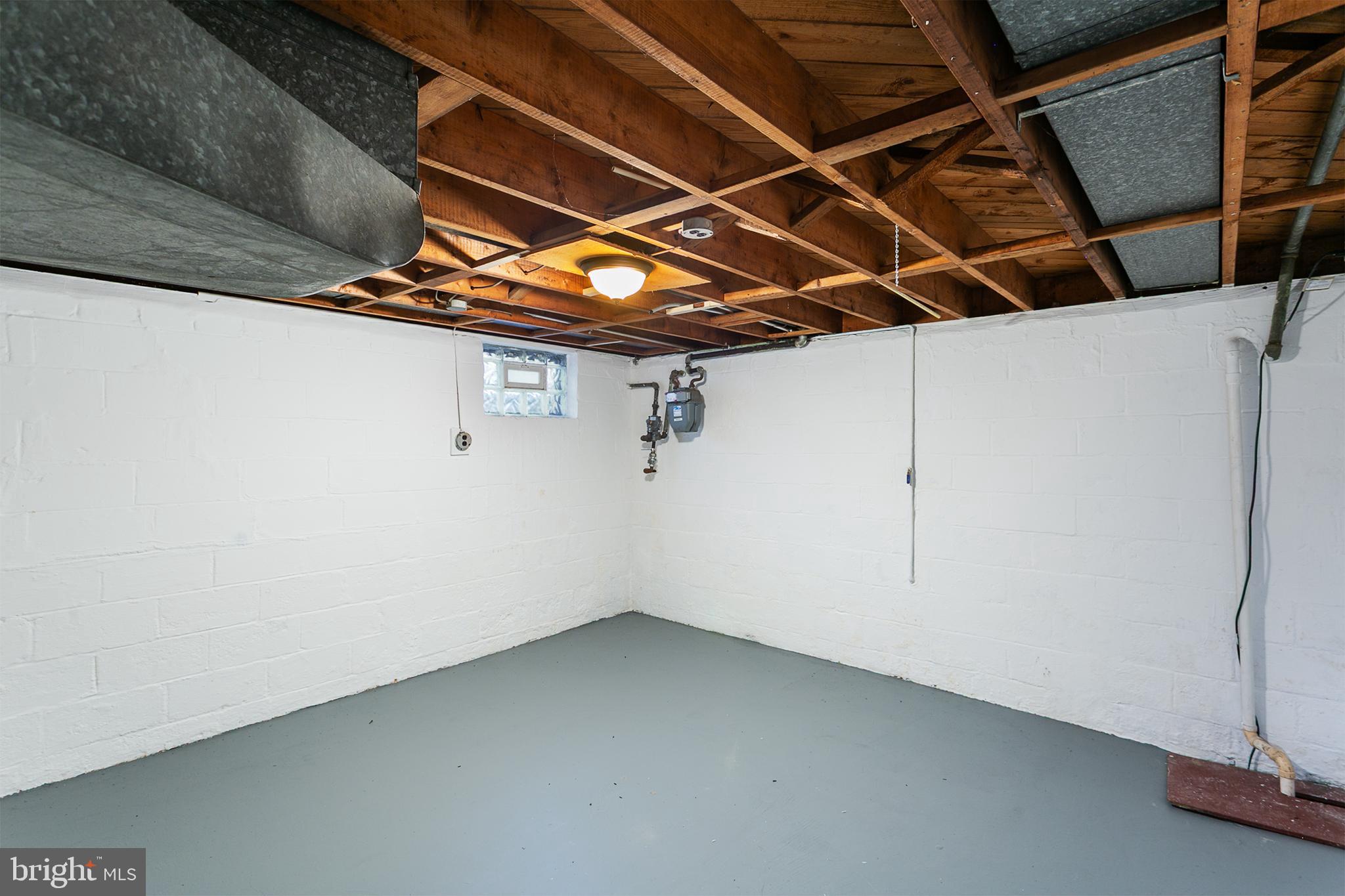 8703 Edgefield Road Baltimore, MD 21234 - Photo 26 of 30 lower level storage w/ 1 of 2 sump pumps