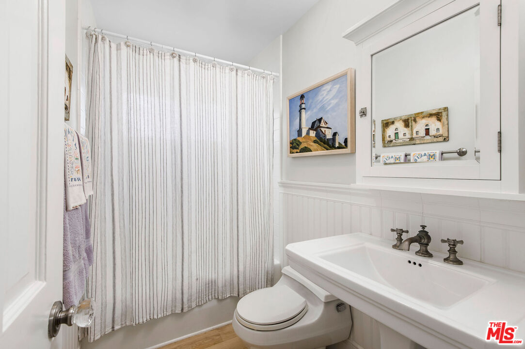 31640 Sea Level Drive Malibu, CA 90265 - Photo 14 of 41 a bathroom with a sink a toilet and a large mirror