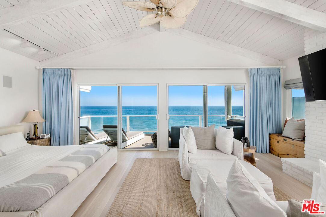 31640 Sea Level Drive Malibu, CA 90265 - Photo 16 of 41 a large bedroom with a bed and large window