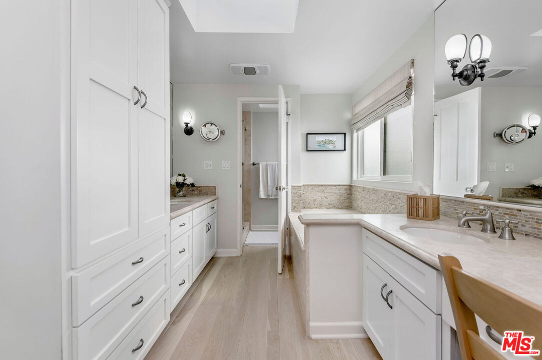 31640 Sea Level Drive Malibu, CA 90265 - Photo 21 of 41 a spacious bathroom with a granite countertop sink mirror and a