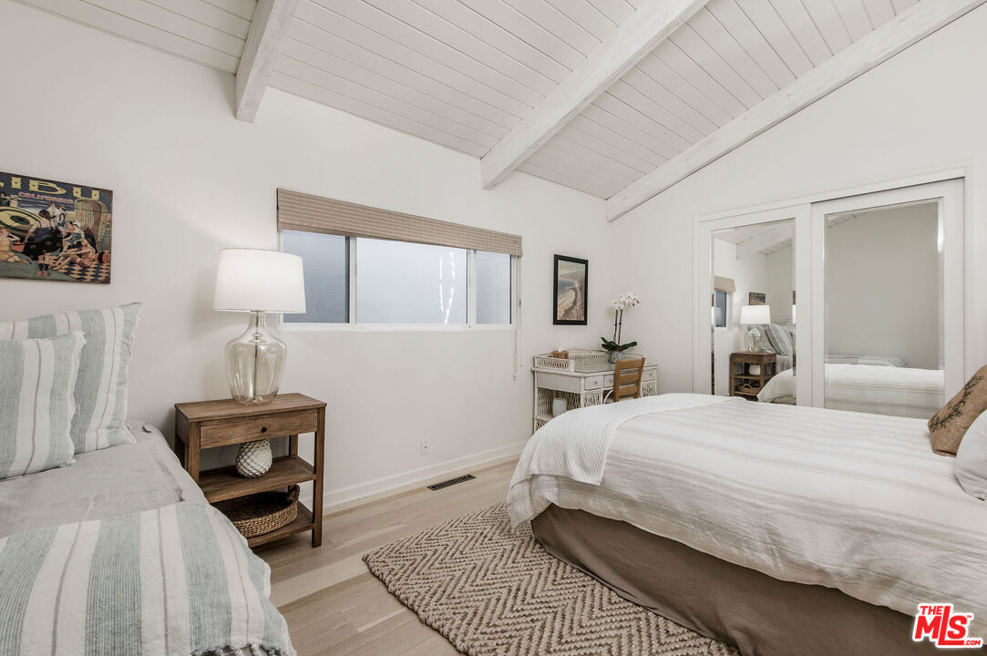 31640 Sea Level Drive Malibu, CA 90265 - Photo 27 of 41 a bedroom with a bed and a lamp on table