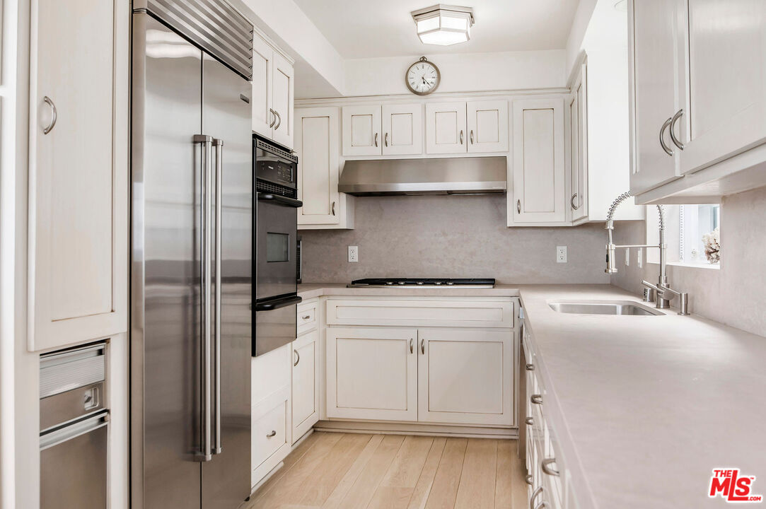 31640 Sea Level Drive Malibu, CA 90265 - Photo 6 of 41 a kitchen with stainless steel appliances cabinets a sink and a refrigerator