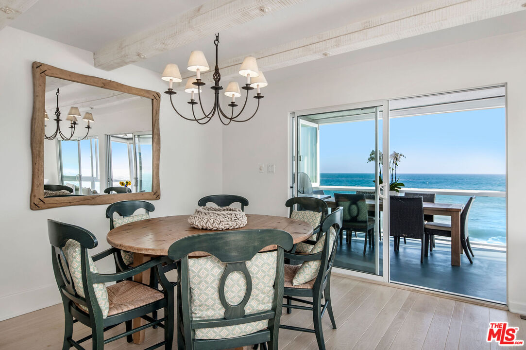 31640 Sea Level Drive Malibu, CA 90265 - Photo 7 of 41 a view of a dining room and livingroom with furniture wooden floor and a chandelier