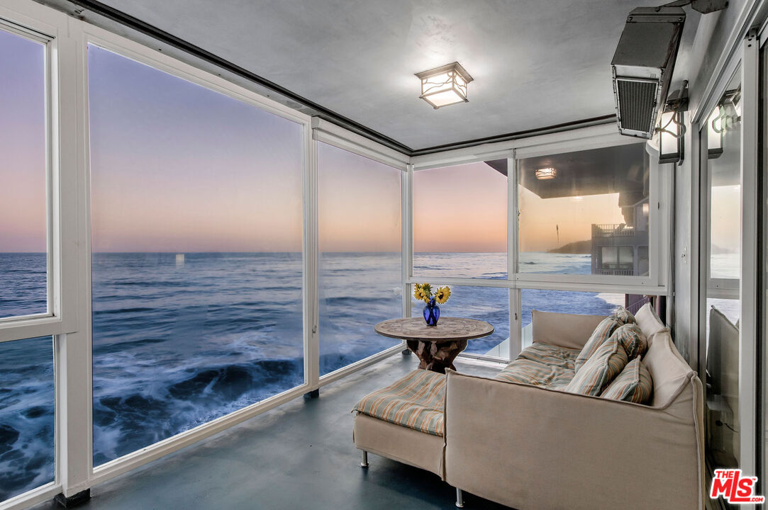 31640 Sea Level Drive Malibu, CA 90265 - Photo 10 of 41 a living room with couches and kitchen view with wooden floor