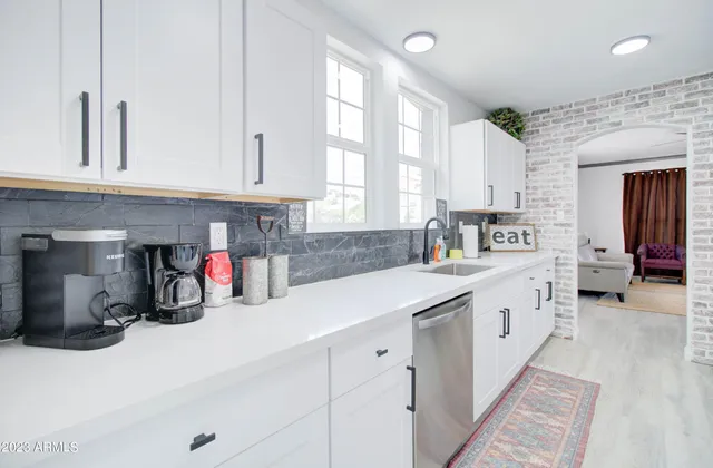 a kitchen with lots of counter top space and wooden floor