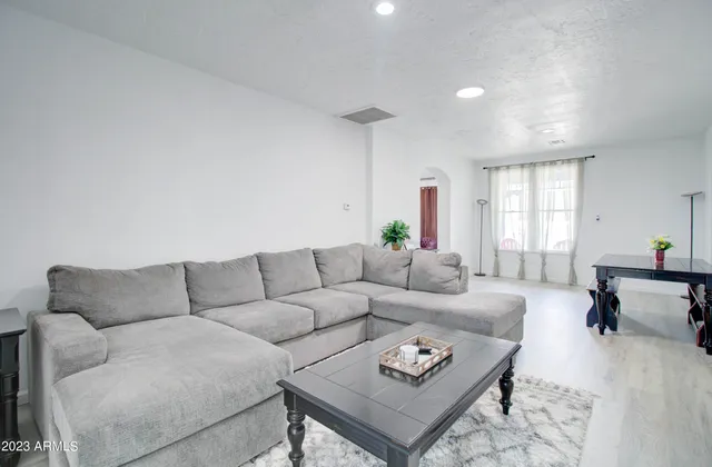 a living room with furniture rug and window