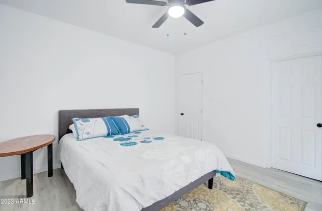 a bedroom with a bed and wooden floor