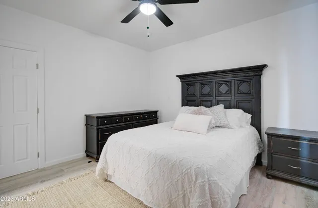 a bedroom with a bed and a ceiling fan