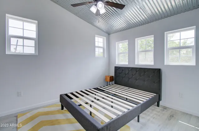 a bedroom with a bed and a chandelier