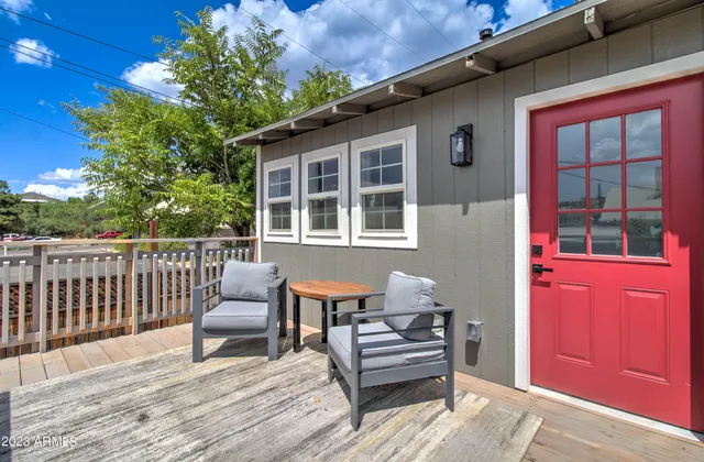 a wooden bench sitting in front of a building