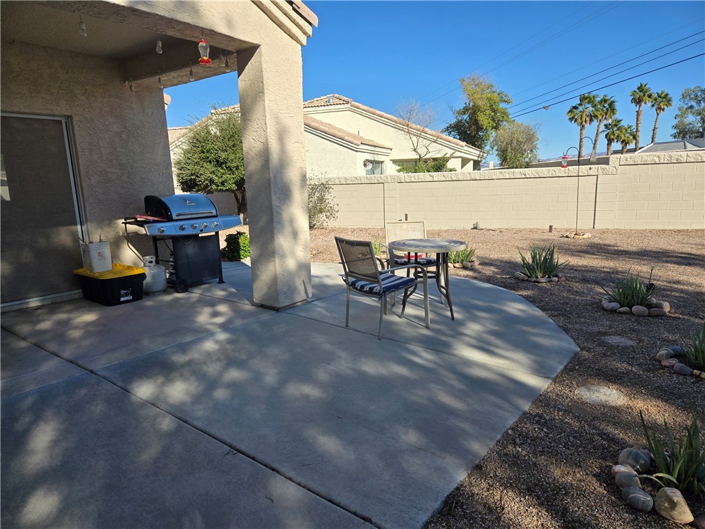 992 Varner Avenue Bullhead City, AZ 86442 - Photo 11 of 14 Backyard with a patio area, grilling area, and outdoor dining area