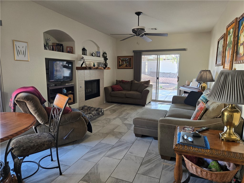 992 Varner Avenue Bullhead City, AZ 86442 - Photo 3 of 14 Living room featuring a fireplace, built in features, and ceiling fan