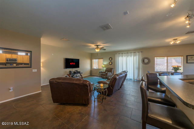 3701 East Northern Dancer Road Tucson, AZ 85739 - Photo 6 of 32 a living room with furniture and a flat screen tv